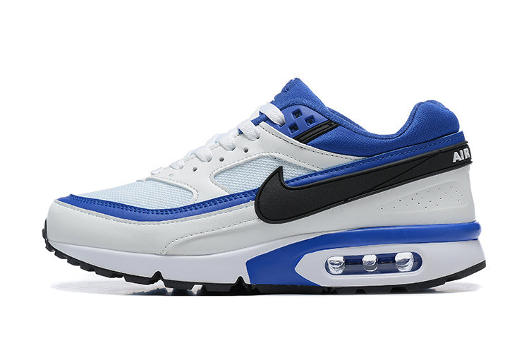 White, blue and black low-top Nike sneaker with a black Swoosh and visible heel Air unit