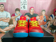 Front view of the pair showing red uppers, bright yellow laces and blue outsoles.