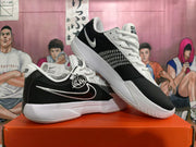 Pair of black and white Nike GT Cut Academy shoes shown from the side
