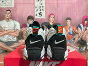 Rear view of the sneakers with heel logos and blue-orange details