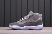 Side profile highlighting the grey upper, white laces, white midsole, and translucent blue outsole.