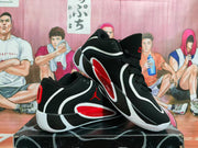Pair of black Jordan basketball shoes shown at an angle, with white and red accents
