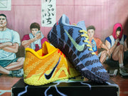 Angled side view showing the yellow and blue sneakers, contrasting laces, Nike Swooshes, and patterned outsoles.