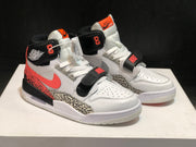 Three-quarter front view of the pair showing contrasting white, black, coral, grey, and elephant-print panels.