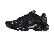 Side view of black grid-pattern sneakers with metallic-look accents and visible sole cushioning