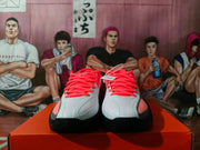 Front view showing the red laces, perforated forefoot panels, and black toe outsoles of the Nike sneakers.
