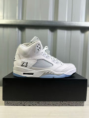 Single white and silver high-top sneaker displayed in side profile on a black box.