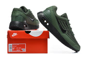 Green and black Nike Air Max VERSA sneakers displayed with a red Nike shoebox; the box label shows a sample size.