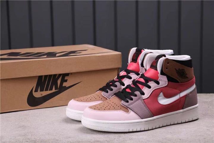Pair of Jordan Air Jordan 1 Zoom Comfort high-top sneakers in dusty pink, red, brown, grey, black, and white, shown with a branded shoe box.
