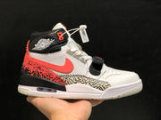 Close side view showing the white upper, coral Swoosh-style side detail, black collar, elephant-print panel, strap, and heel air unit.