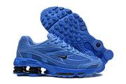 Blue Nike Shox Ride 2 sneaker with a textured outsole shown beside the shoe.
