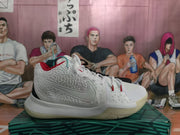 Side view of the predominantly white sneaker showing a textured upper, Nike side branding, red accents, and a sculpted rubber midsole.