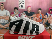 Side view of a white and black Nike sneaker showing layered panels, mesh sections, and visible cushioning.