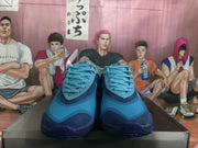 Front view of blue and navy Nike basketball sneakers with matching laces and layered toe panels.