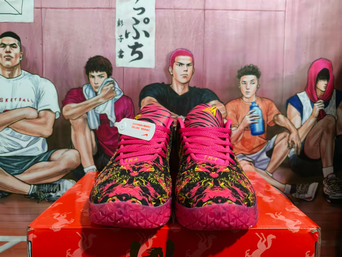 Front view of Nike basketball sneakers with a vivid multicolor patterned upper, pink laces, and purple soles.