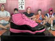 Side profile of a pink and black high-top sneaker showing the Jumpman logo, glossy black side panel, and pink midsole.
