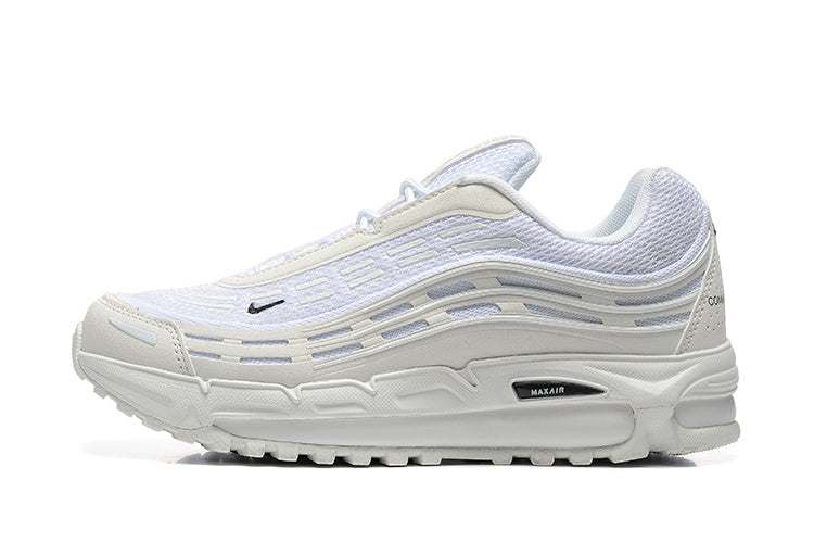 Side view of white Nike sneakers with layered wavy panels and a visible Max Air detail.