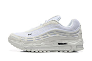 Side view of white Nike sneakers with layered wavy panels and a visible Max Air detail.