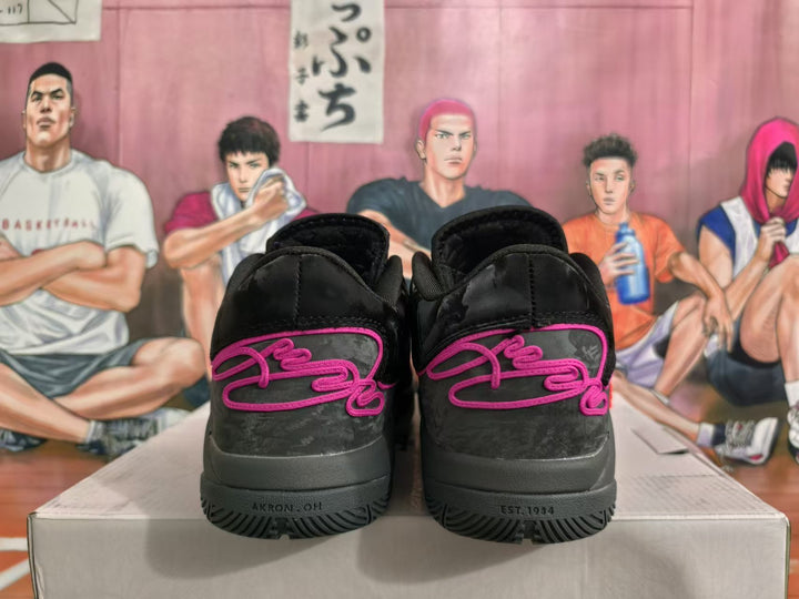 Rear view of black basketball shoes with pink detailing and charcoal-gray heel panels