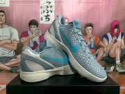 Angled product view showing both gray and blue basketball sneakers with textured uppers and contrasting heel panels.