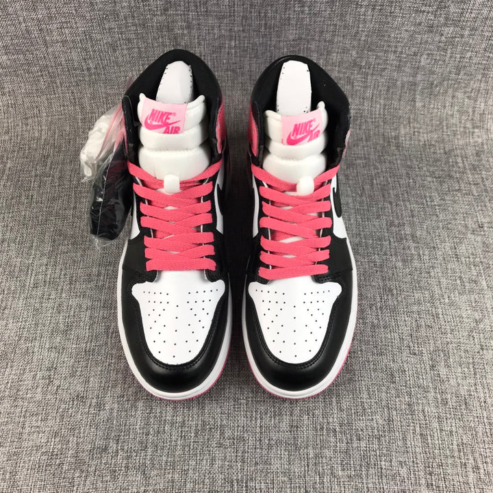 Top view of black, white, and pink high-top sneakers with pink laces and padded tongues.