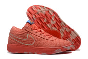 Coral sneakers shown with one outsole facing upward, displaying a herringbone tread pattern and contrasting lighter sections.