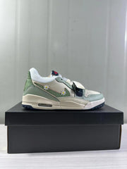 Side view of mint green and white low-top Jordan sneakers with daisy side details on a black shoebox.
