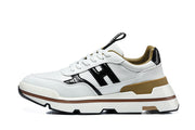 Side profile of a white sneaker with black side panels, tan-gold heel trim, and a layered sole.