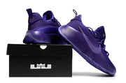 Purple sneaker arranged beside a black shoebox.