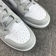 Close-up of the perforated white toe boxes, gray overlays and textured stitching.