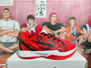 Side view of a red Nike basketball sneaker with black laces, black graphic detailing, and a white midsole.