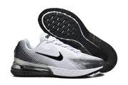 Pair of white and black Nike sneakers shown with the patterned outsole visible.