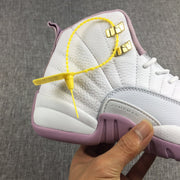 Close-up side view showing the heel, gold-toned hardware and light gray panel.