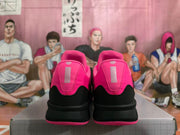 Rear view of the pink and black Nike basketball shoes, showing the pink heel panels and black heel sections.