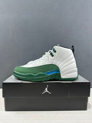 Side view of one white and green high-top sneaker resting on a black shoebox.