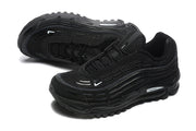 Pair of black sneakers shown from a front three-quarter angle, with one shoe displaying the outsole.