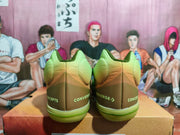 Heel view showing Converse and Concepts branding on the green shoes.