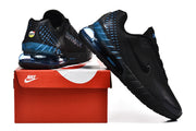 Black and blue Nike Air Max sneakers displayed on a red shoebox.