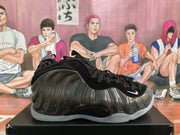 Side profile of a black Nike basketball sneaker showing the reflective molded upper, black laces and translucent outsole.