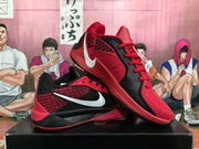 Angled view of red and black Nike basketball sneakers displaying the side branding, lace design, and contrasting outsole.