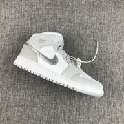 Angled side view showing the white and silver high-top sneaker, layered panels and padded collar.