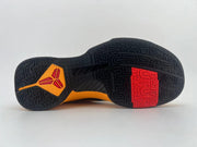 Full outsole view showing black tread with red and orange accent sections.