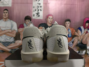 Rear view of the gray-green Nike sneakers showing heel panels, black Swoosh details, and textured soles.