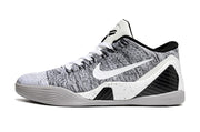 Side view of a white and black low-top basketball shoe.