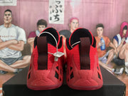 Rear view showing the red and black Jordan sneakers, heel pull tabs, and contrasting black heel details.