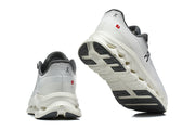 White and grey On shoes shown from rear and outsole angles.