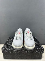 Front view of the pair of Jordan Spizike Low sneakers showing grey laces, pink lace accents, elephant-print toe overlays, and cream-colored midsoles.