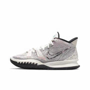 White Nike Kyrie 7 basketball sneaker with layered black Swoosh branding, black outsole, and printed heel graphics.
