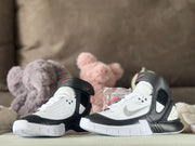 Pair of black-and-white high-top sneakers shown from the front and side.