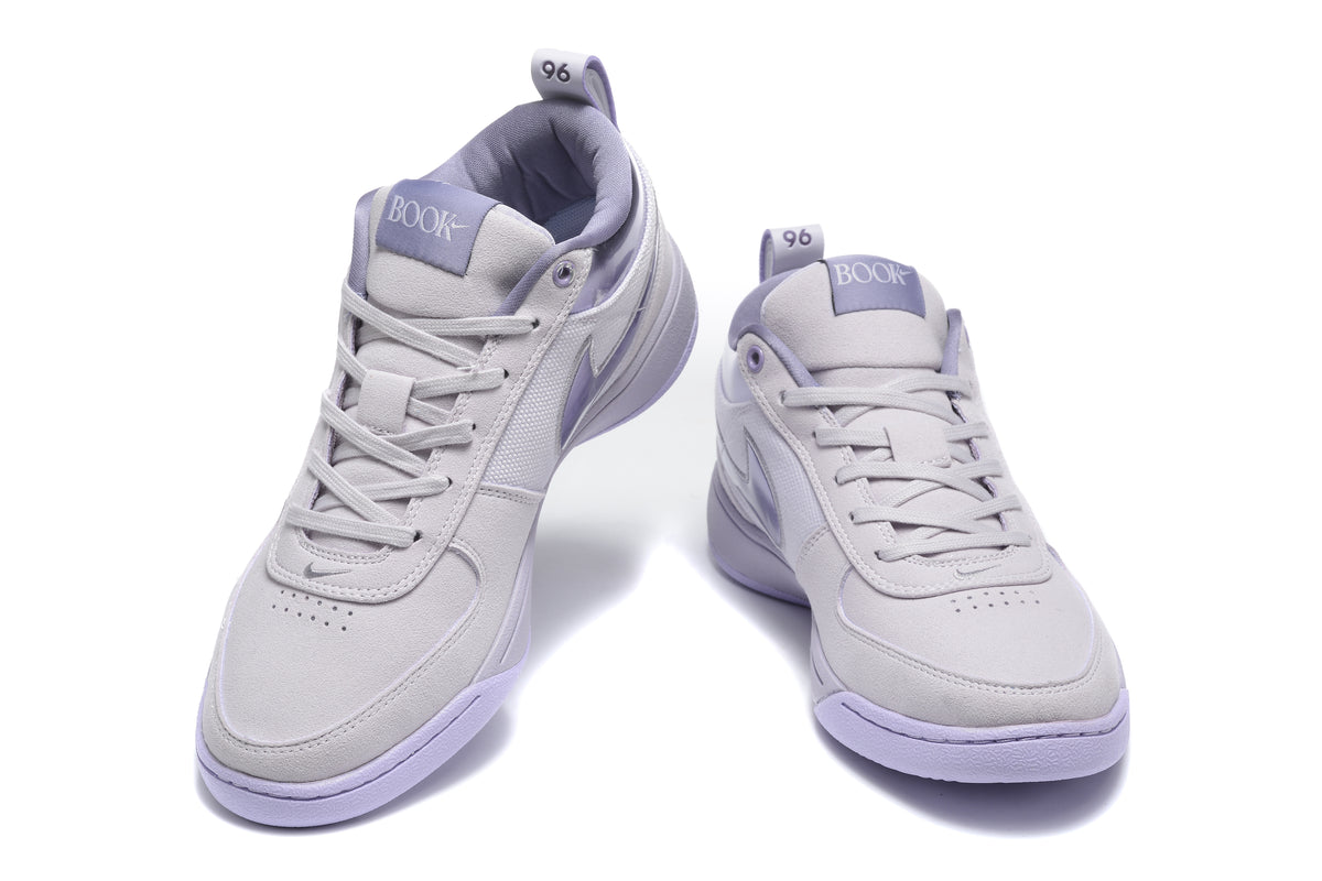 Pair of purple Nike low-top sneakers shown from the front and three-quarter angle.